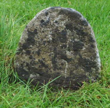 Simple relief cross on round-headed slab | Christy Cunniffe