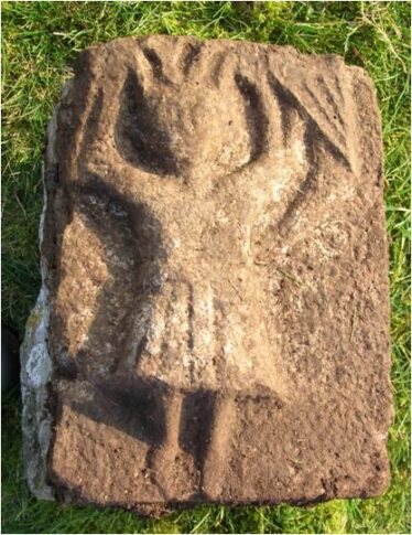 Late medieval carving of birds pecking human head | Christy Cunniffe