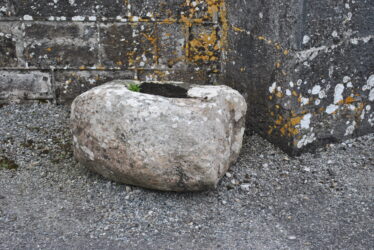 Bullaun stone beside Ballinakill Catholic church. | Christy Cunniffe