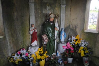 Large  green statue of St Colman and a pair of small statues of Our Lady and the Sacred Heart. | Christy Cunniffe