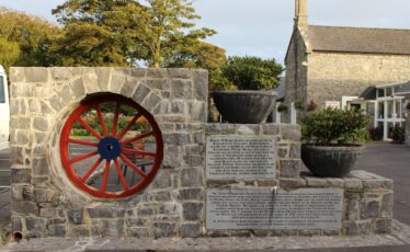 Broken Chariot Wheel with plaque containing history of Toghermore House. | Photo: Bernadette Forde