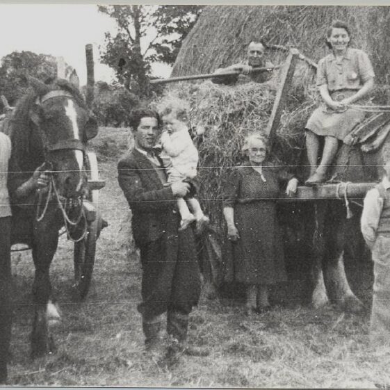 Saving the Hay L-r: Ned Mullen, Ned's nephew Johnny Maloney, Baby John Maloney, Ban Hughes, Daisy Hughes and two visitors home for the summer (photo taken in the 1930s) | Photo: Out and About Magazine 2004