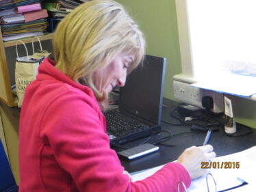 Rosaleen Molloy in parish office working on Parish History | Photo: Bernadette Forde, Togher