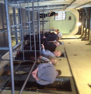 Tour guide showing Tour group, the prison.