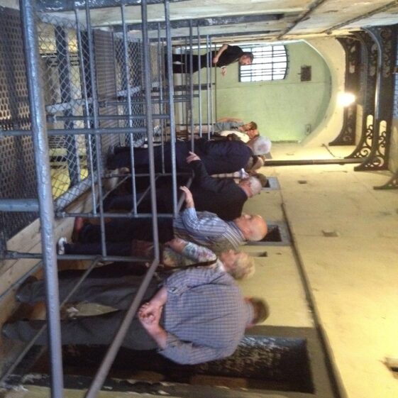 Tour guide showing Tour group, the prison. | Photo: B. Forde
