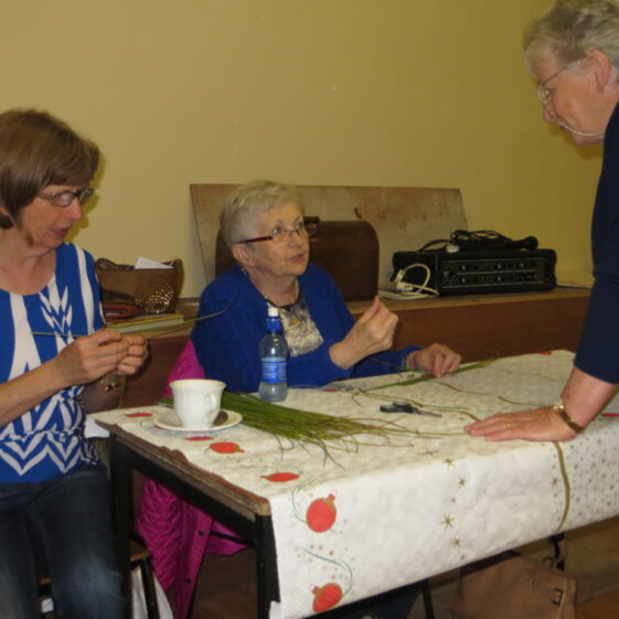 Learning how to make St. Brigid's cross with Mary Ellen Burke, watched by Bríd Fahy, Peak Boreen on left and Eileen Reynolds, Cloonlusk | Photo: Bernadette Forde