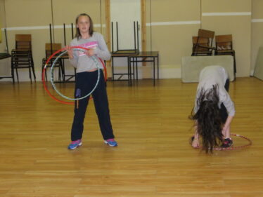 Rebecca and Alina Rooney ltrying to master the hoola hoop in Barnaderg Community Centre, during Bealtaine Festival