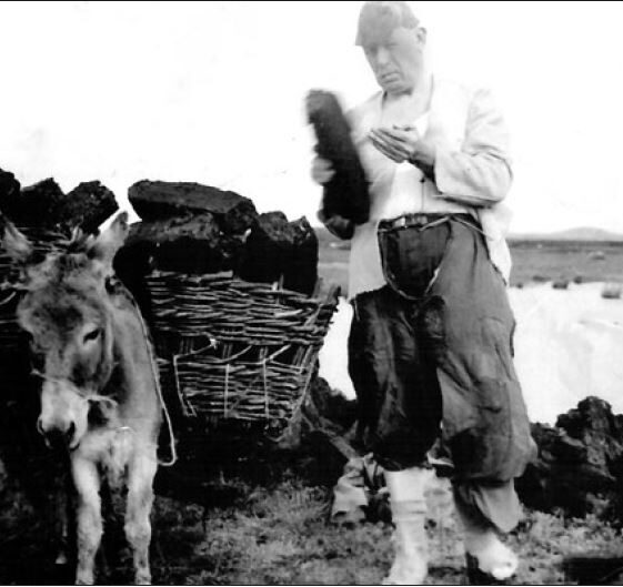 Michael Keeler working in the bog - Photo Credit Tom Keeler Jnr Michael Keeler working in the bog. The creel used to carry the turf would have been made from local willow | Photo Credit Tom Keeler Jnr