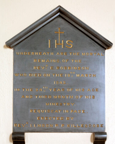 The stone marking the final resting place of Fr. E Robbinson in Menlough Church | © Gerry Costello Photography