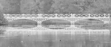 Close up of the White Bridge at Woodlawn with its reflection in the lake