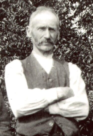 Tom Melody, 1927 standing tall and straight with arms folded
