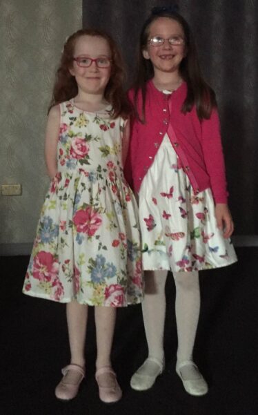 Two girls in pretty dresses enjoying the night out