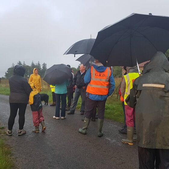 Bernie leads way along Golden Mile. People brave the weather and walk Golden Mile | Cathy Seale 2017