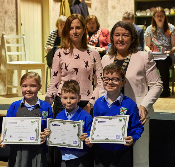 three pupils from Milltown school getting certificates Sandra Burke, Cllr Eileen Mannion with MNS pupils | Photo: Tuam Photo Studio