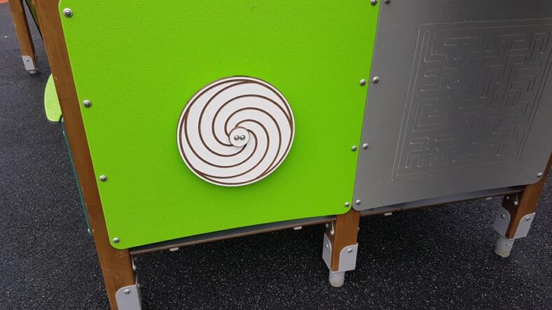 Spiral spinning wheel with a maze beside it