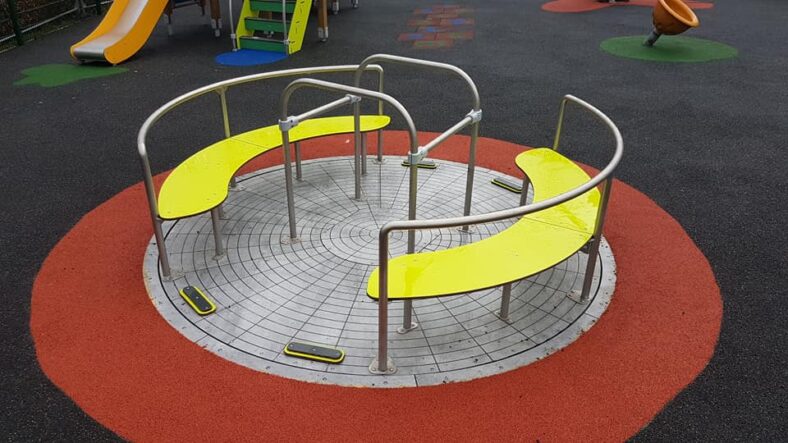 Wheelchair friendly roundabout that can take 2 wheelchairs at the same time while also accommodating other children or friends of those on wheelchairs in the seats!