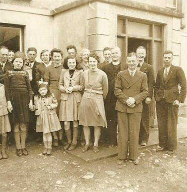 Fr. Edward outside his sister Mary Finnegan's house in Dunmore.  His nephew Pat Finnegan in the front to  his left along with others who are as yet unknown | Debbie Hadley, USA