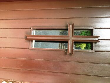 Exterior teak door showing the cross worked into the design | Bernadette Forde
