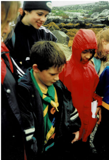 Gearoid and Brid Connolly with Claire Nestor in red. Wet but enthralled! | Photo: Bernadette Forde