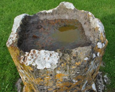 View of the damaged rim of the Lickmolassy late medieval baptismal font. | Christy Cunniffe