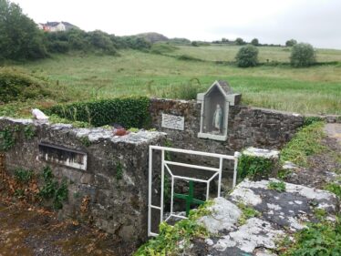 Overlooking holy well showing statue of Holy Mary in wall