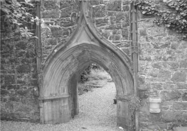 Detail showing medieval doorway to abbey remains. Pointed curve to the top, wide entrance