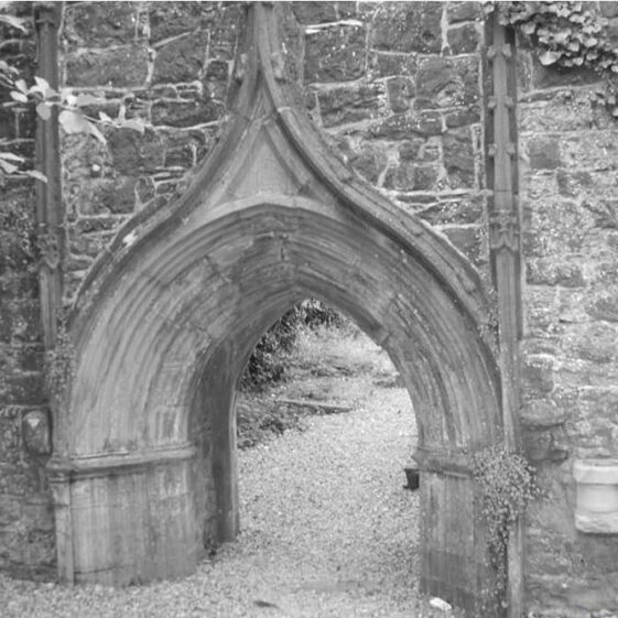Detail showing medieval doorway to abbey remains. Pointed curve to the top, wide entrance | Angela Wallace 2022