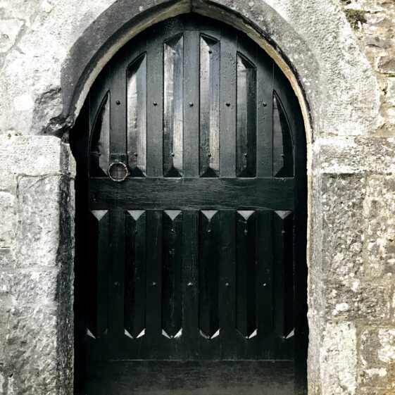 Black stained Solid timber door to six storey tower house at Aughnanure Castle, Oughterard. Within an arched opening | Antoinette Lydon