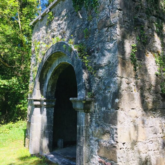 Arched doorway at Inchogoill, note the battered wall toward the base. | Antoinette Lydon