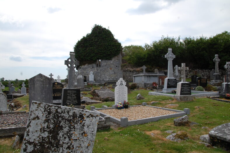 Stone church with ivy within graveyard