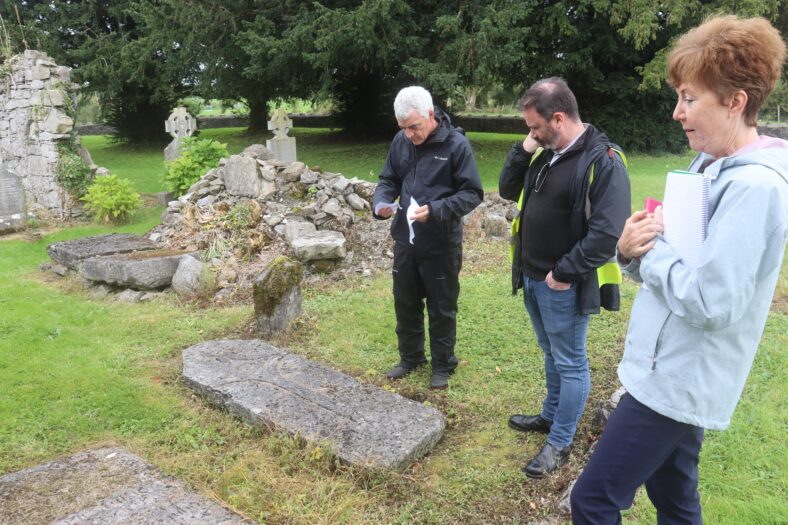 Dominic Delany, Fergal Mc Namara and Peggy Monahan study medieval graveslab Kilboght | B. Doherty