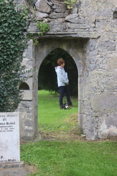 Peggy and her dog viewed through the doorway at Kilboght