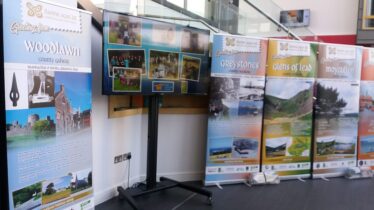 Digital Posters displayed on screen, Pull up banners alongside displaying Daoine agus Ait Project