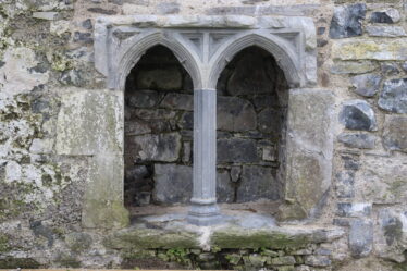 double arch in wall alcove, restored, limestone