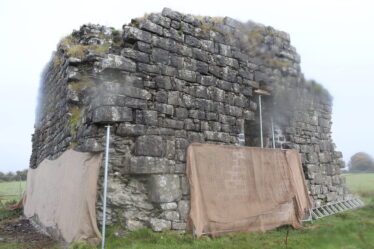 stone building with supporting scaffold and sheets protecting the work from the elements | B. Doherty 2022