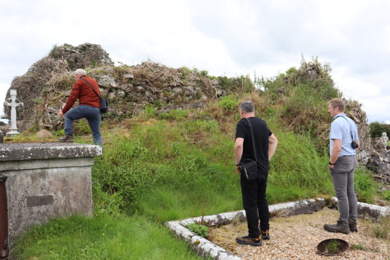 Three men looking at the ruins of Killogilleen Church | B. Doherty 2023