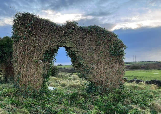 Stone wall. cleared of ivy, arched opening evident | Laurik Mathieu