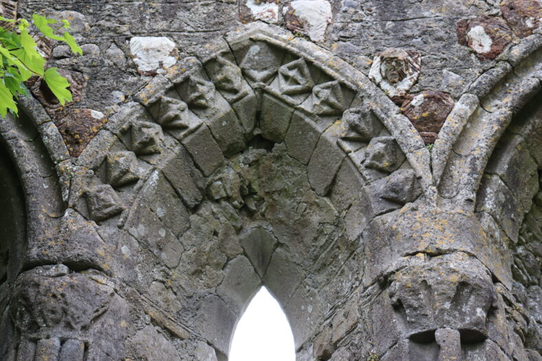 A series of carved stone heads over a pointed arch | B. Doherty 2023