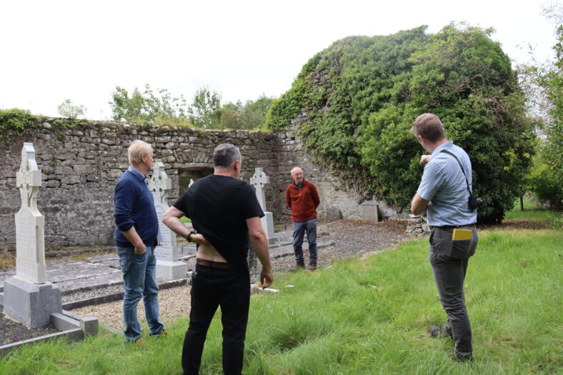 Consultation in progress at Killeeneen Church and Graveyard. Two archaeologists and structural engineer assess the remains of Parish church, Killleeneen | B. Doherty 2023