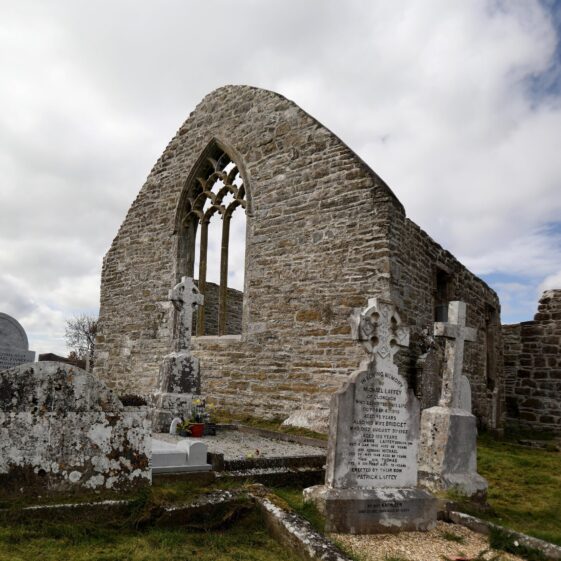 Arched tracery window within church ruin, recently conserved with grave | Hany Marzouk