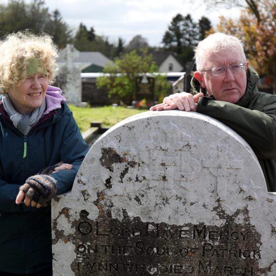 A lady and gentleman lean on a headstone at St. Kerrills | Hany Marzouk