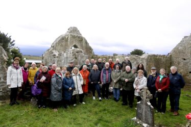 Group of people standing in front of the ruin of Kilboght Church | Hany Marzouk