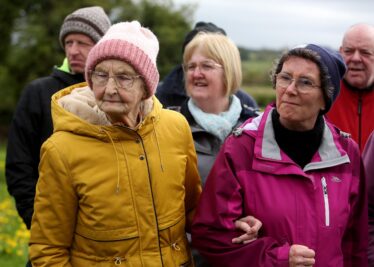 Ladies look on during tour of Kilboght Church and Graveyard