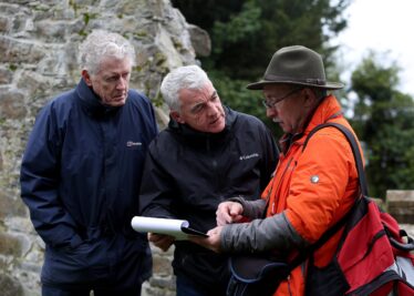 Three men discuss archaeology at Kilboght