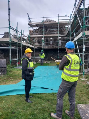 People talking in front of scaffolding | B. Doherty 2024