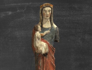 Image of Our Lady of Clonfert Statue, holding the baby Jesus in her right arm, her left arm is broken. The Christ Child is supported on his mother’s right arm while he plays with a tress of her hair. | Digital Heritage Age