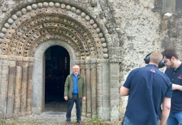 Christy being recorded as he is standing at Romanesque doorway of St. Brendan's Cathedral, Clonfert
