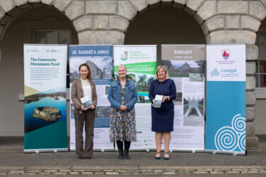 Three people standing in front of banners at Collins Barracks | Bryan Brophy©