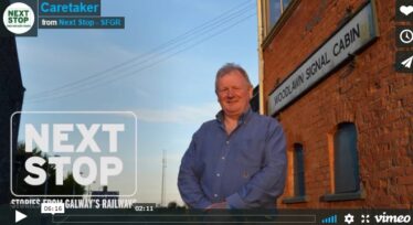 Des Doherty smiling outside Woodlawn Signal Cabin wearing blue shirt