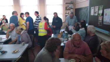 people gathered in Woodlawn School for refreshments after walk